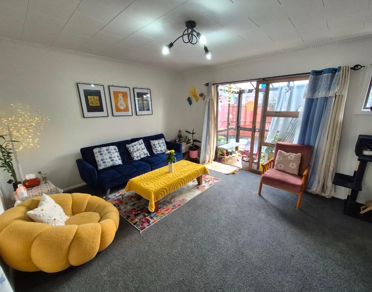 Wide view of navy sofa and mustard seating